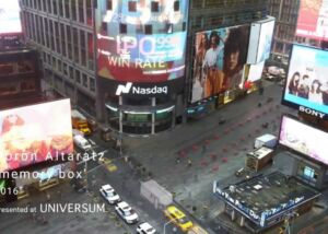 Still from the video Memory Box: a view over a busy city square with large billboards, with the title Memory Box overlaid