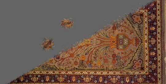 Still from the video Woven Time: an ornate carpet cut into a triangle, with two small fragments floating on a grey background